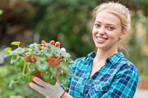 Gardener discussing a complaint with a client in a garden